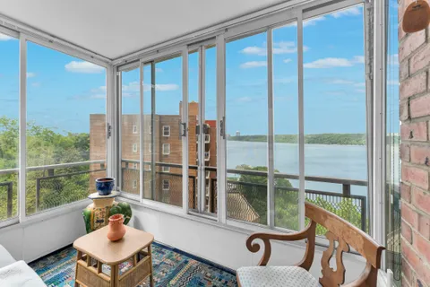 a living room with furniture and a floor to ceiling window