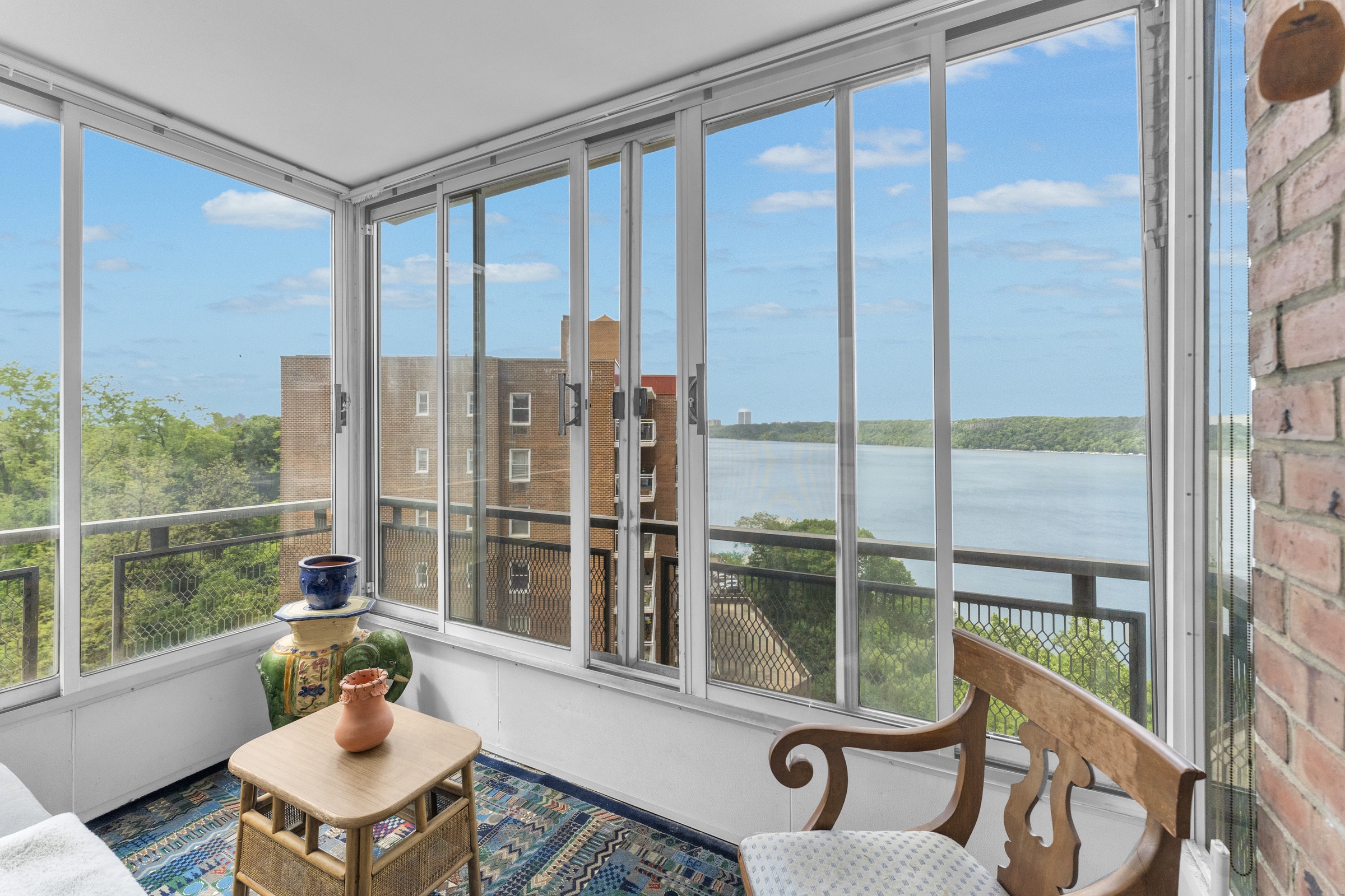 2621 Palisade Avenue, Unit 11J Bronx, NY 10463 - Photo 5 of 19 a living room with furniture and a floor to ceiling window