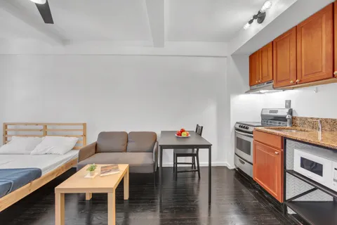 a living room with furniture and a wooden floor