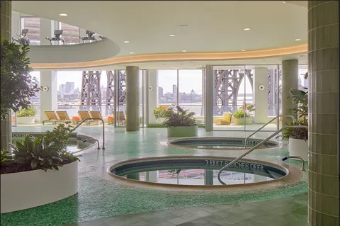 a view of a living room and kitchen floor to ceiling window and kitchen