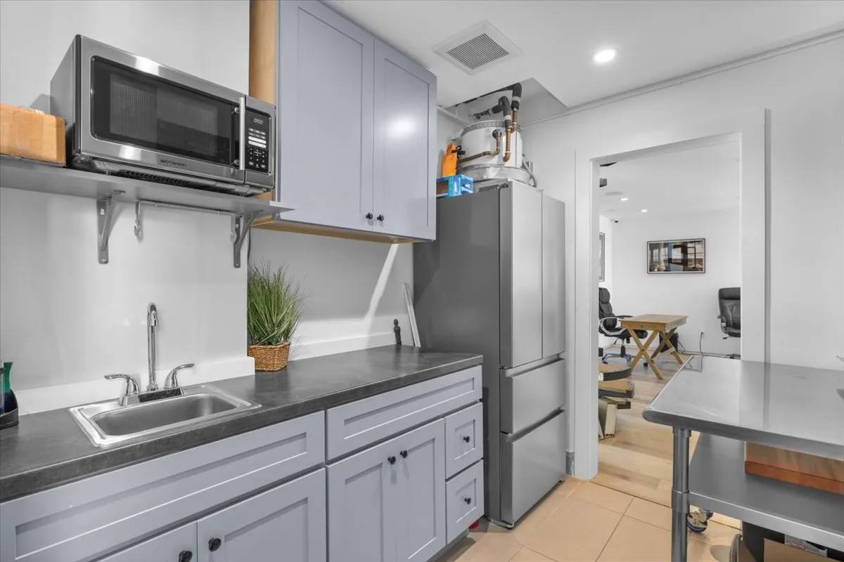 a kitchen with appliances a counter space and cabinets