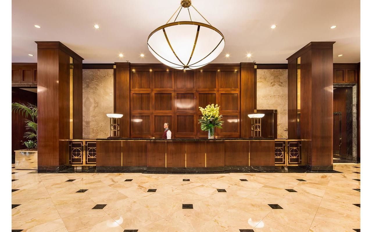 200 East 69th Street, Unit 4N Manhattan, NY 10021 - Photo 9 of 13 a bathroom with mirror shower and glass door