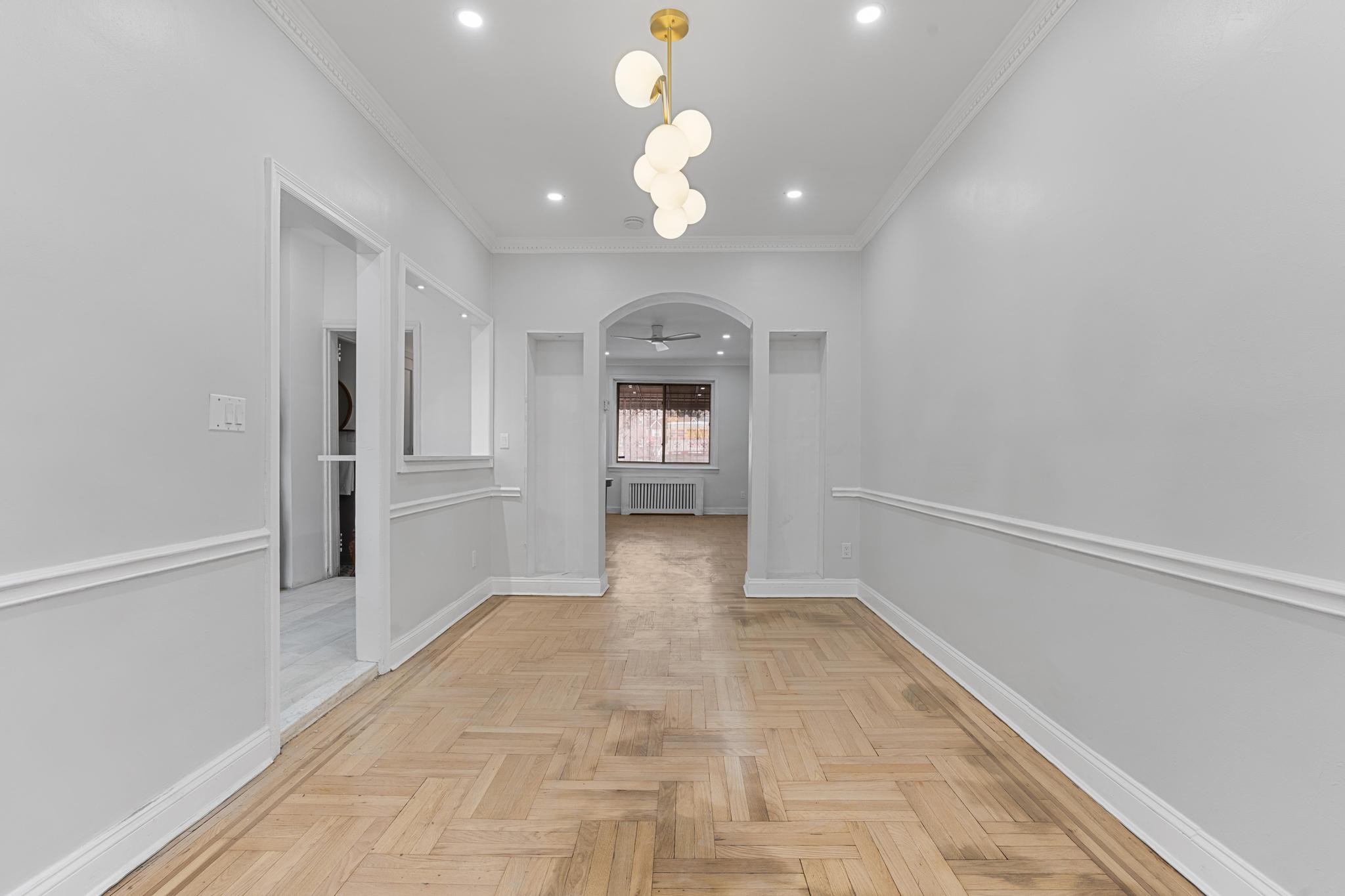 237 Remsen Avenue, Unit 1 Brooklyn, NY 11212 - Photo 2 of 16 a view of a room with an empty space and a ceiling fan