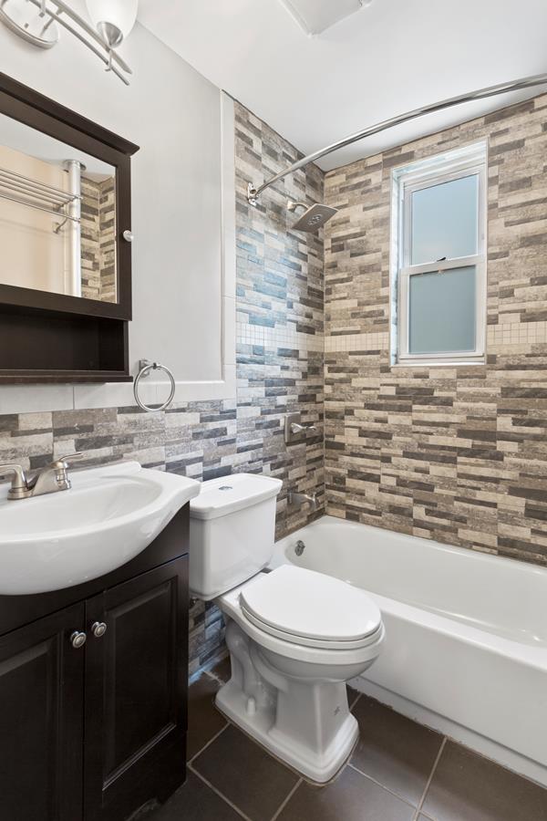 11-15 30th Drive, Unit 2F Queens, NY 11102 - Photo 5 of 6 a bathroom with a sink toilet and shower