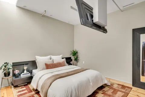 a bedroom with a bed and a mirror