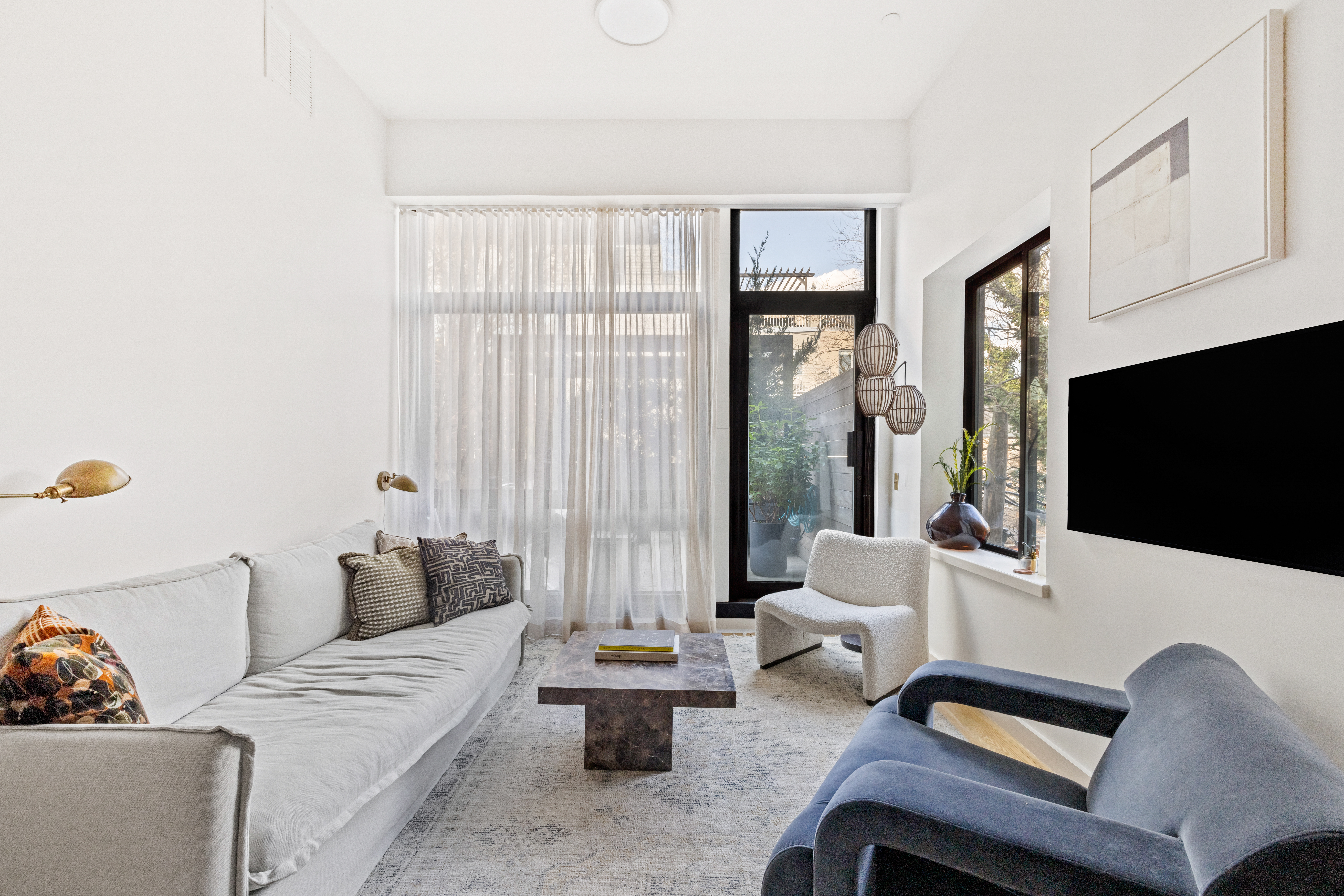 735 Dean Street, Unit 2B Brooklyn, NY 11238 - Photo 3 of 11 a living room with furniture and a flat screen tv