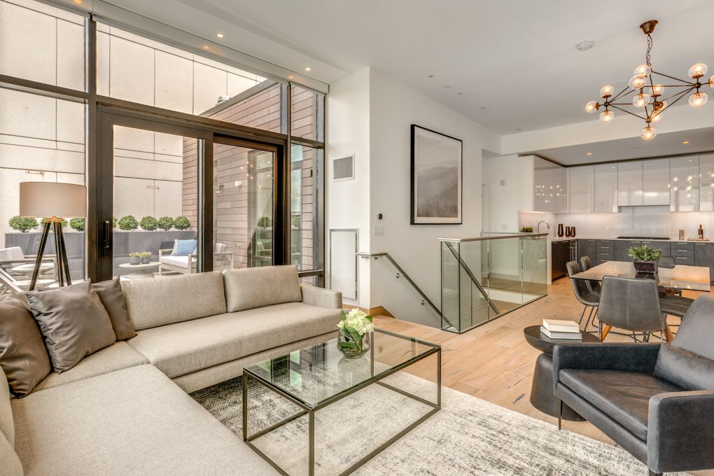 a living room with furniture and a floor to ceiling window