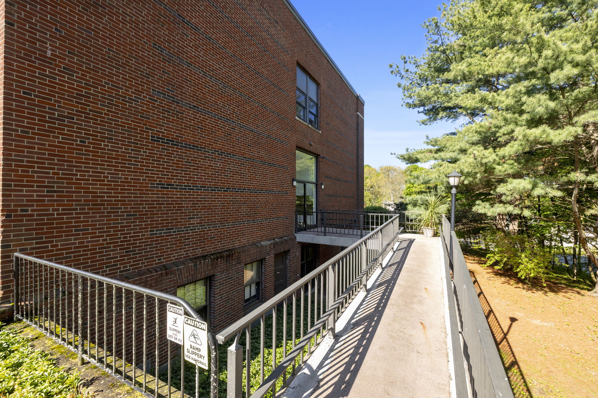 61 Wright Street, Unit 102 Stoneham, MA 02180 - Photo 23 of 26 a view of balcony with wooden floor and fence