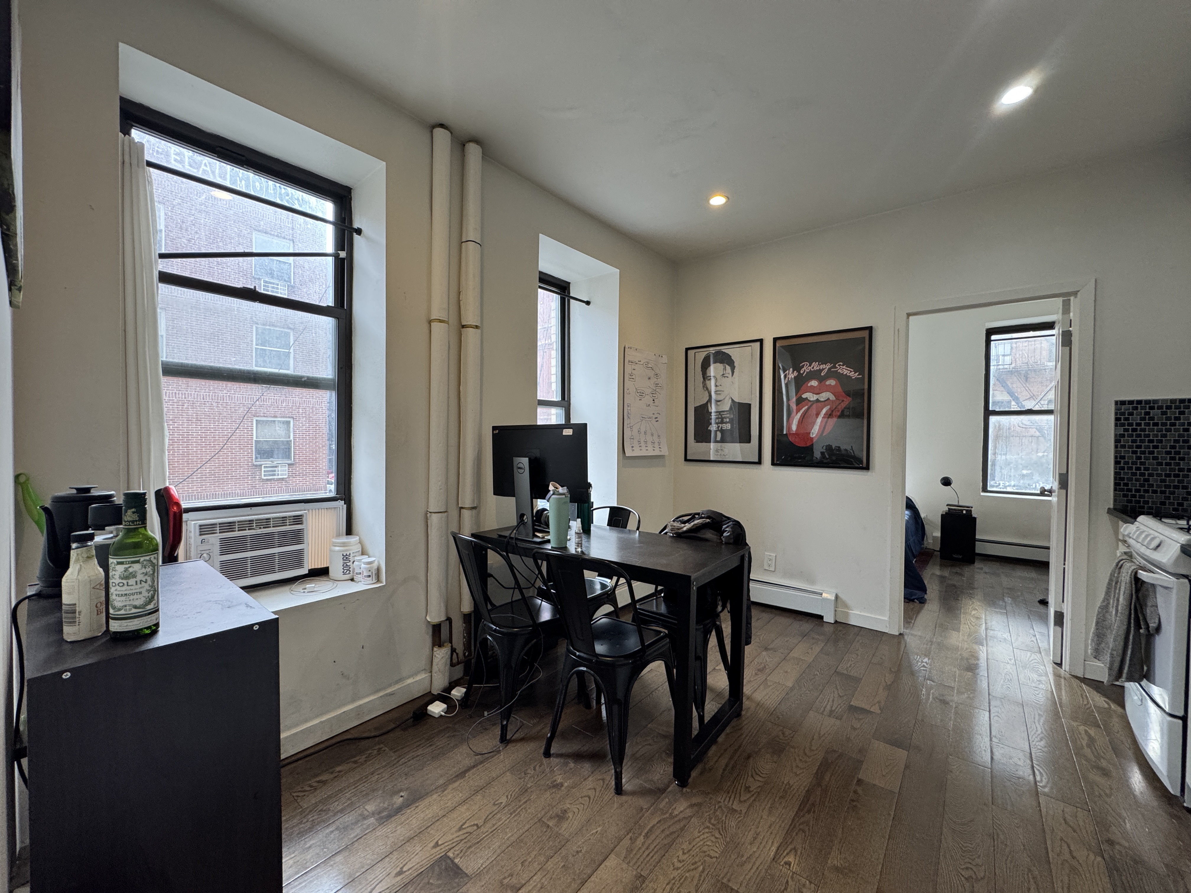 108 Stanton Street, Unit 1A Manhattan, NY 10002 - Photo 2 of 11 a view of a dining room with furniture window and wooden floor