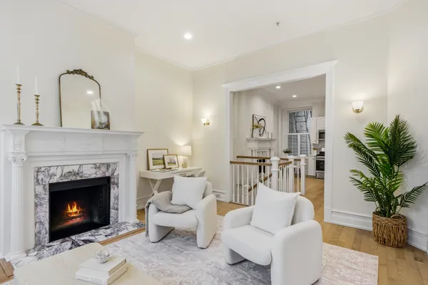 a living room with furniture and a fireplace