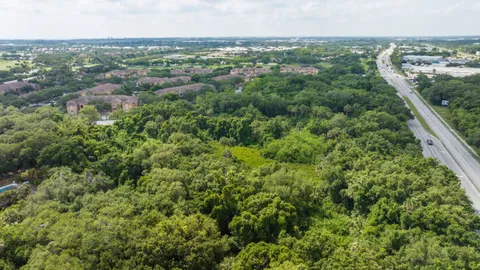 an aerial view of residential houses with outdoor space and trees
