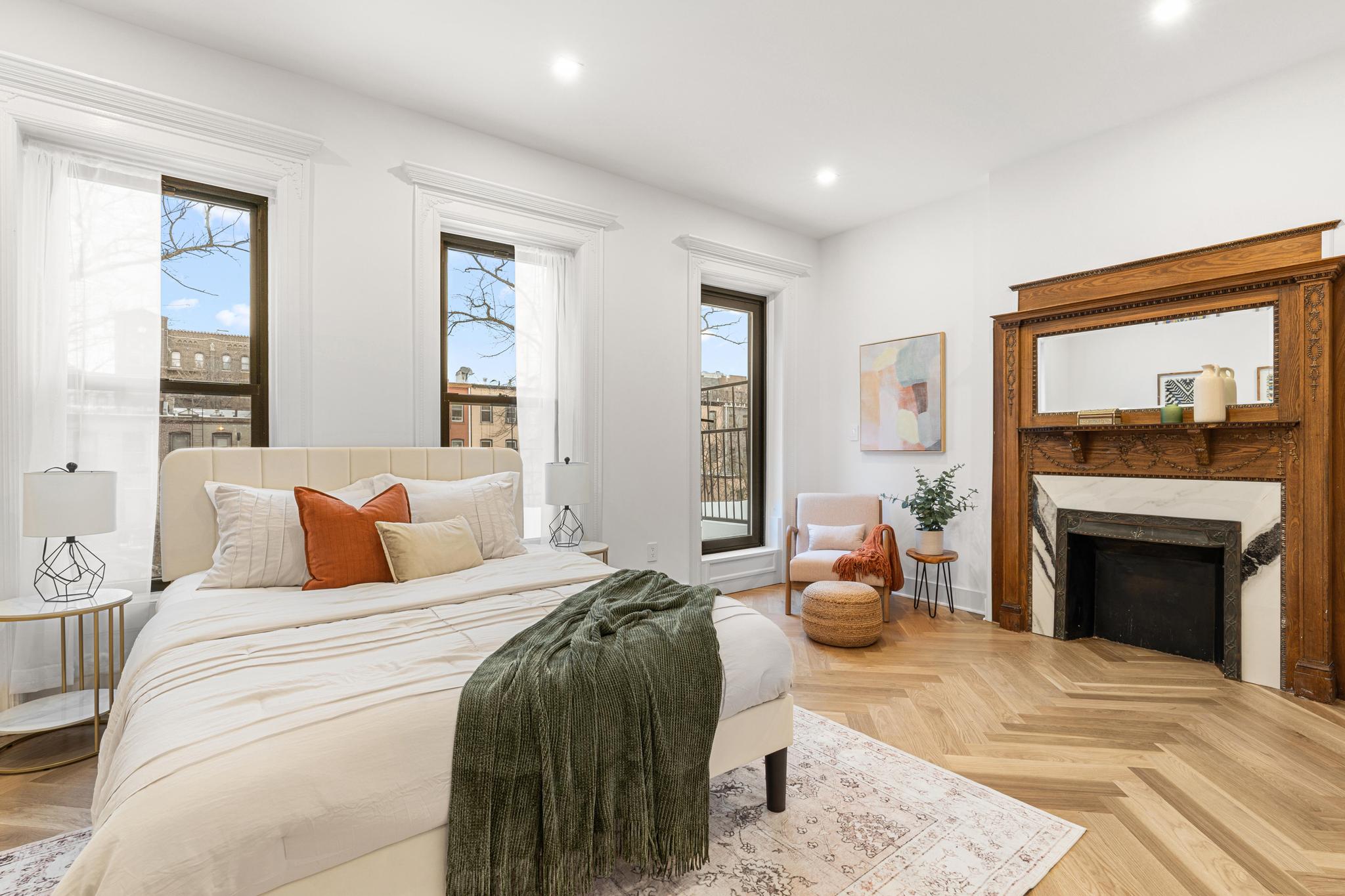 987 Sterling Place Brooklyn, NY 11213 - Photo 5 of 16 a bedroom with a bed and a fireplace