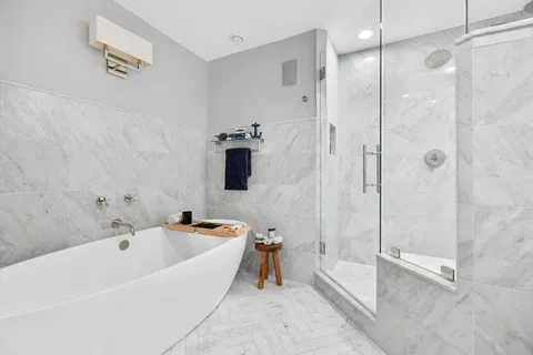 a bathroom with a tub and a shower