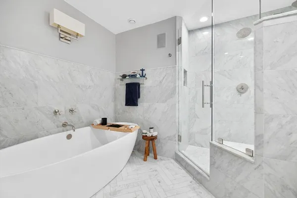 a bathroom with a tub and a shower