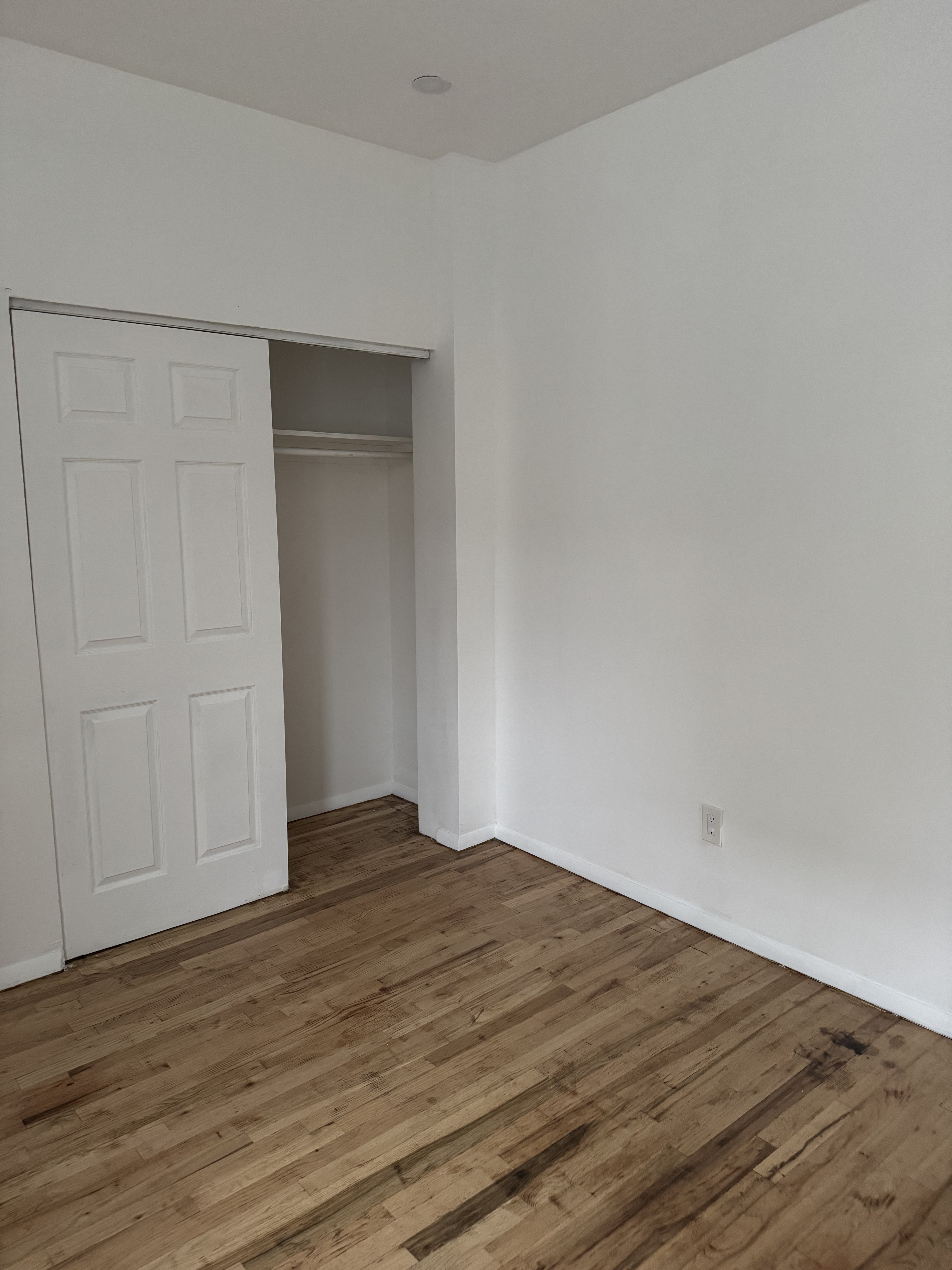 149 Sterling Street, Unit 4D Brooklyn, NY 11225 - Photo 5 of 7 a view of empty room with wooden floor