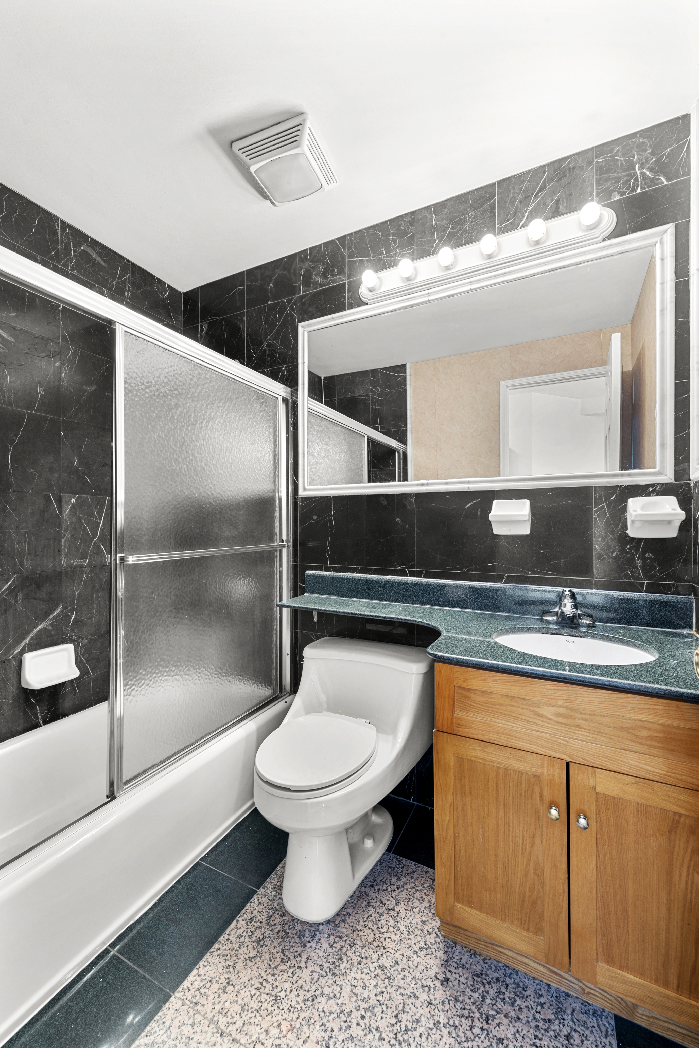62 Rivington Street, Unit 9A Manhattan, NY 10002 - Photo 5 of 6 a bathroom with a sink a toilet and a mirror