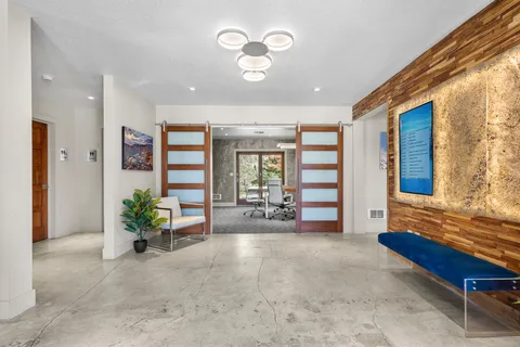 a living room with furniture and large windows