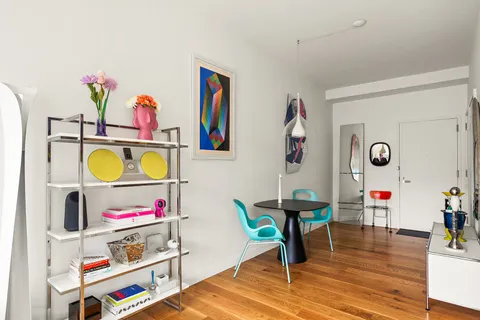 a living room with furniture and painting on the wall