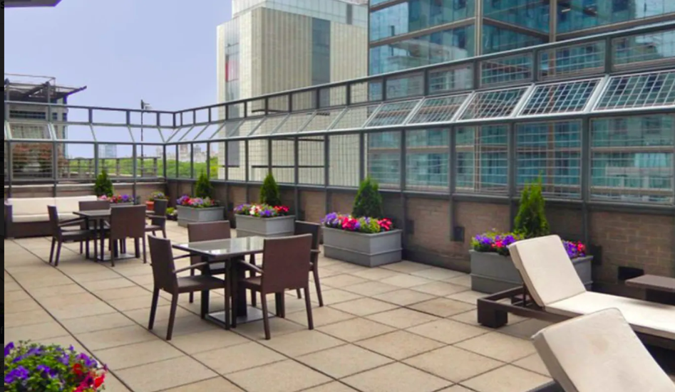 301 West 57th Street, Unit 22D Manhattan, NY 10019 - Photo 9 of 12 a view of a dinning tables and chairs in the patio