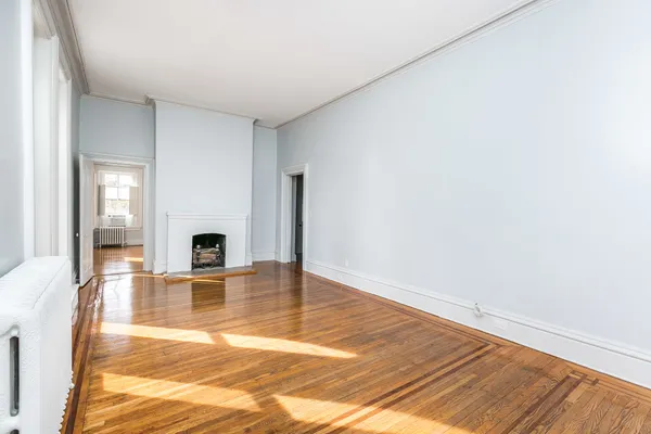 an empty room with wooden floor