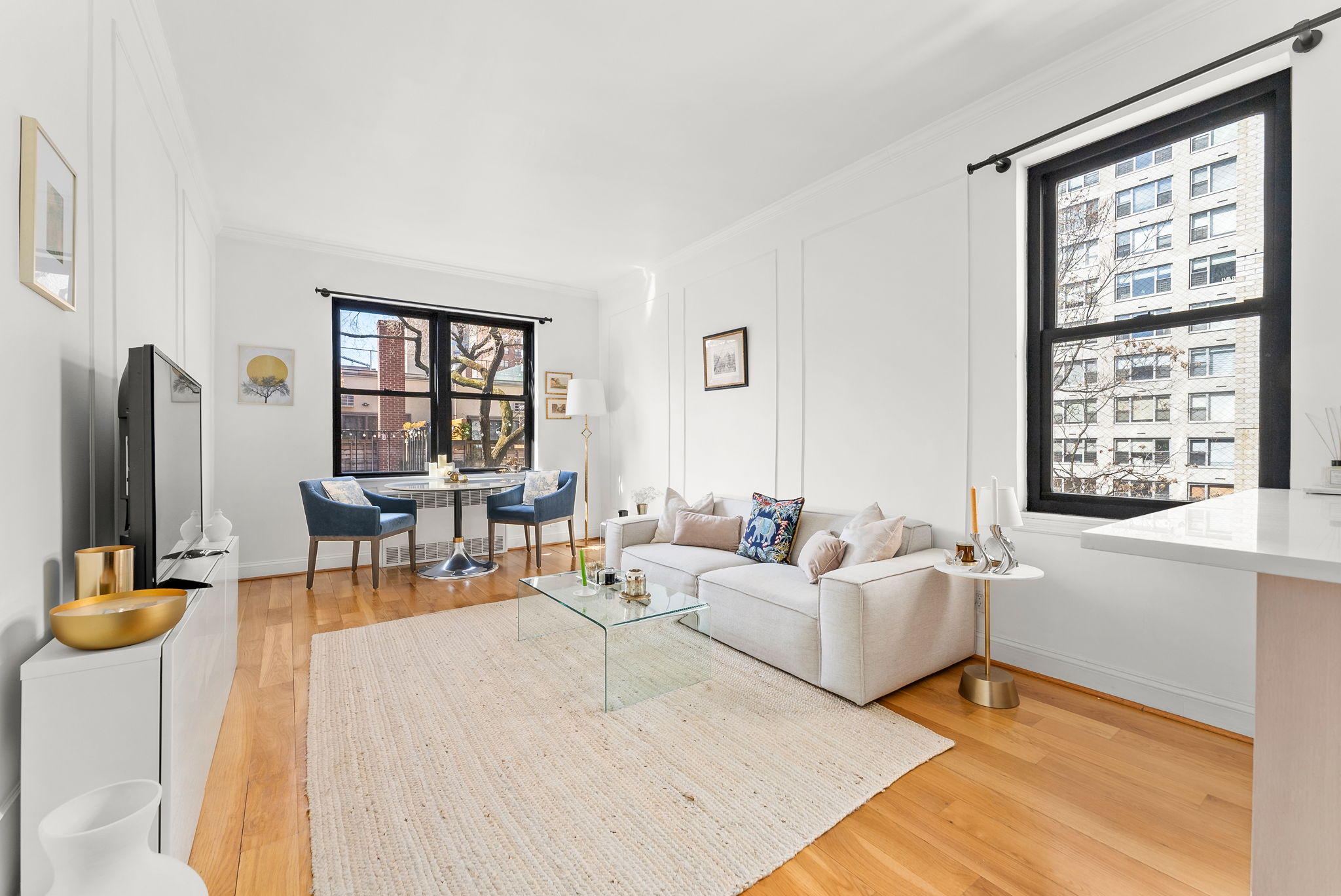 512 East 83rd Street, Unit D4 Manhattan, NY 10028 - Photo 1 of 21 a living room with furniture and large window