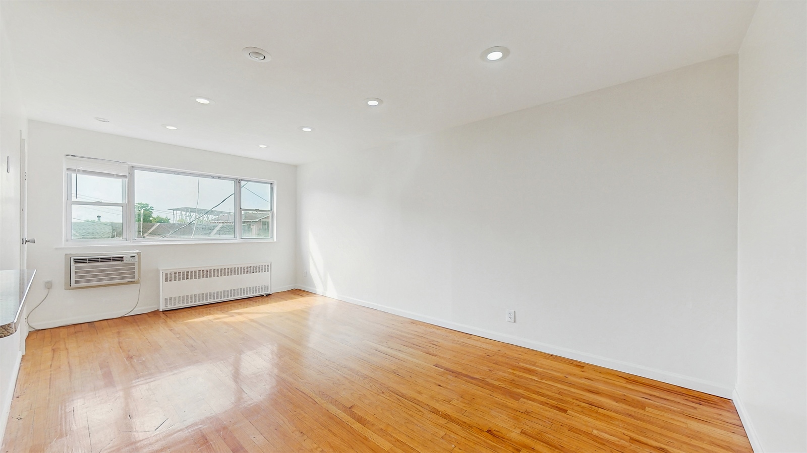 295 Conklin Avenue, Unit 3 Brooklyn, NY 11236 - Photo 4 of 15 a view of an empty room with a window
