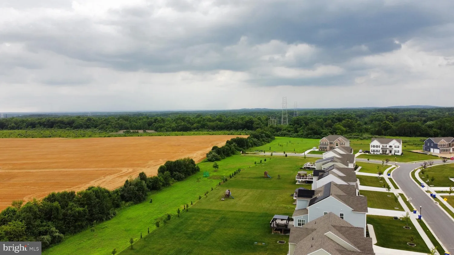 an aerial view of a house with a yard lake big yard and large tree