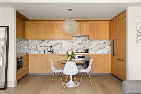 a view of a dining room with furniture and a chandelier