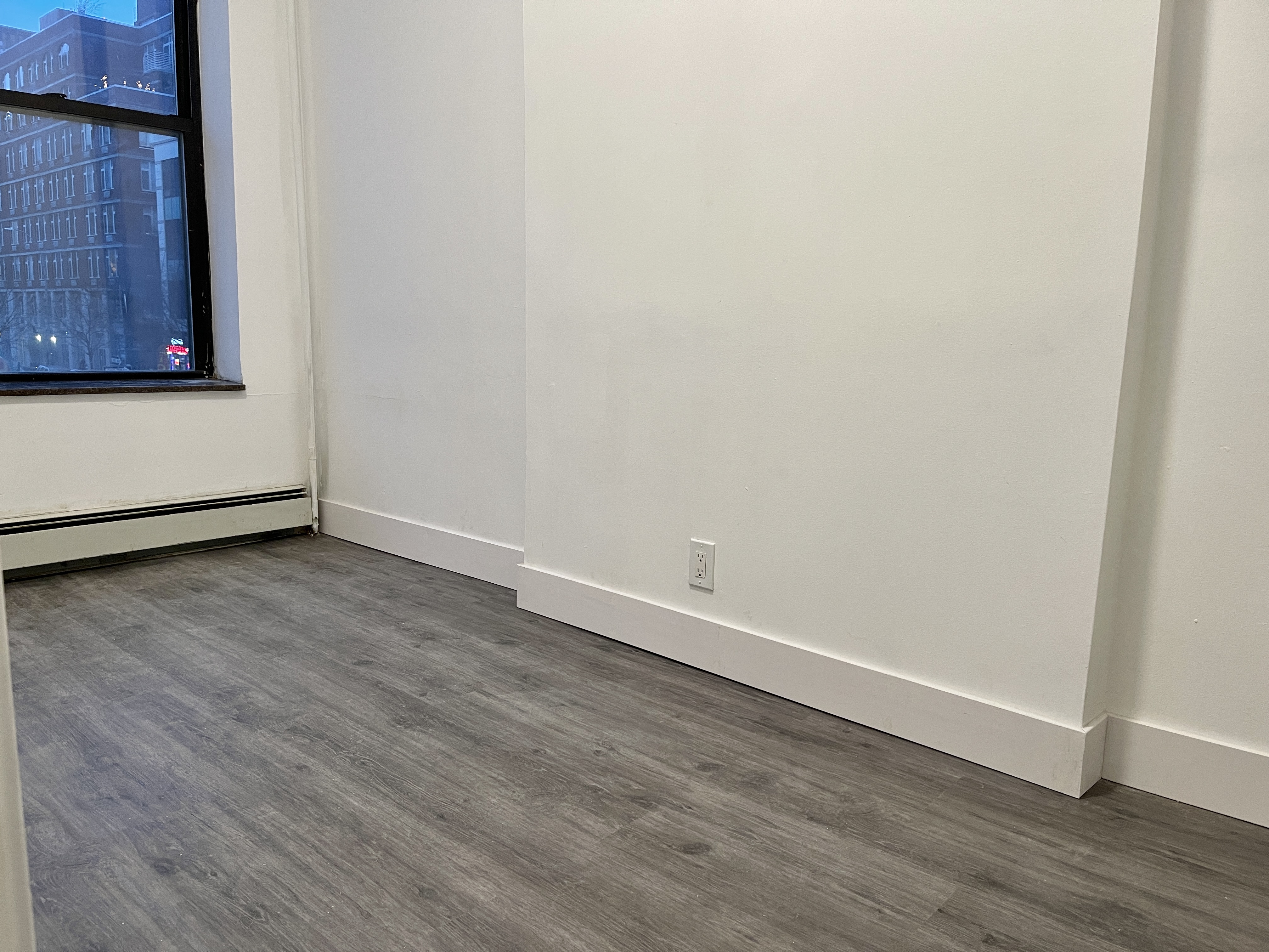 1999 3rd Avenue, Unit 1 Manhattan, NY 10029 - Photo 10 of 23 a view of an empty room with wooden floor