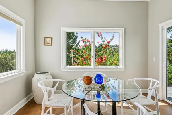 a view of a dining room with furniture and wooden floor