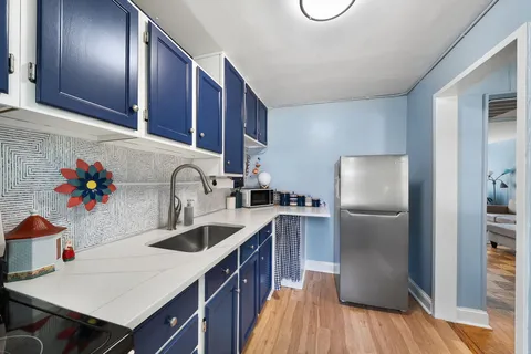 a kitchen with granite countertop a sink stove and refrigerator