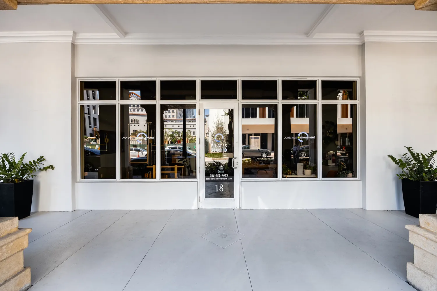 a view of a house with potted plants
