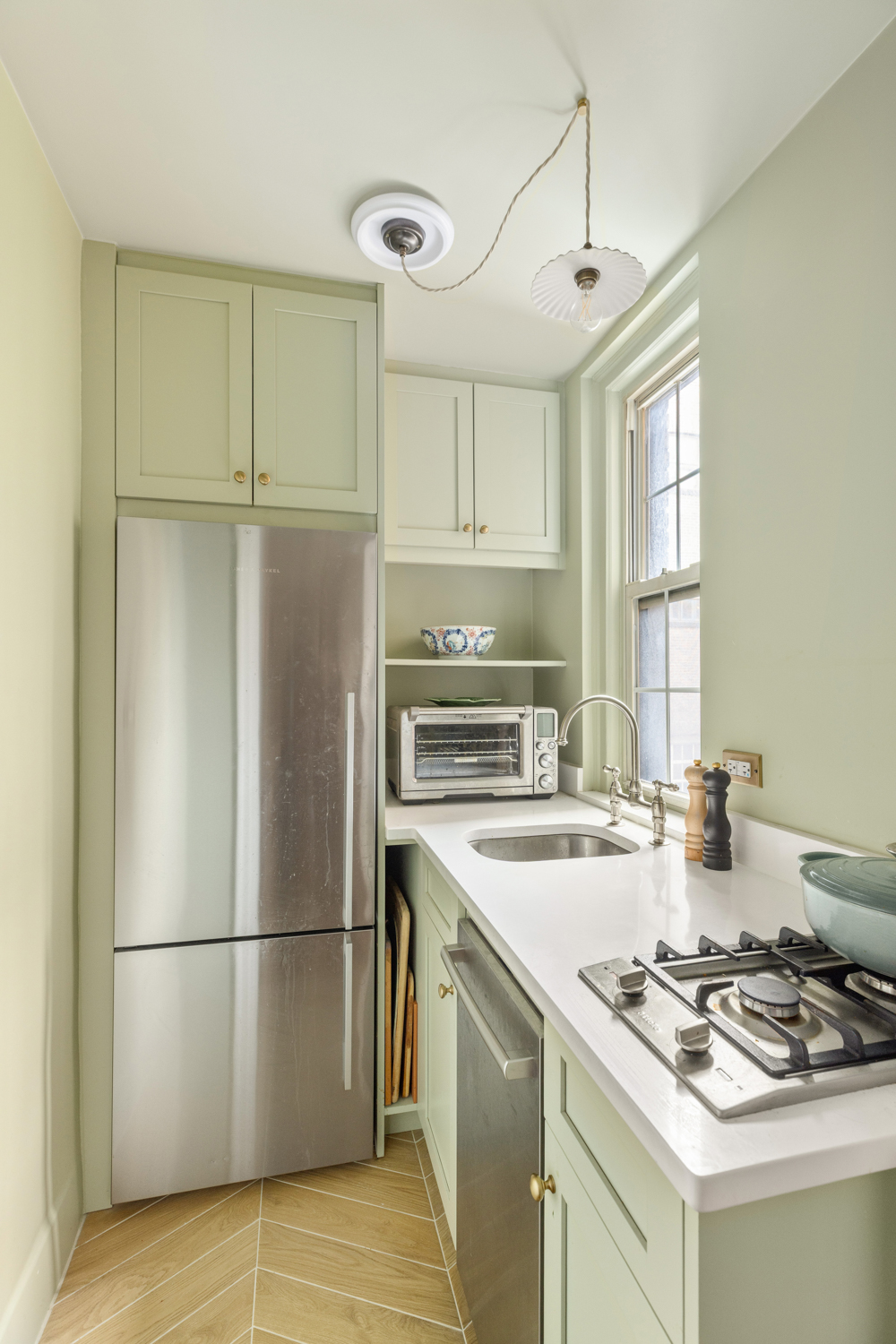 a kitchen with a appliances a sink and a refrigerator