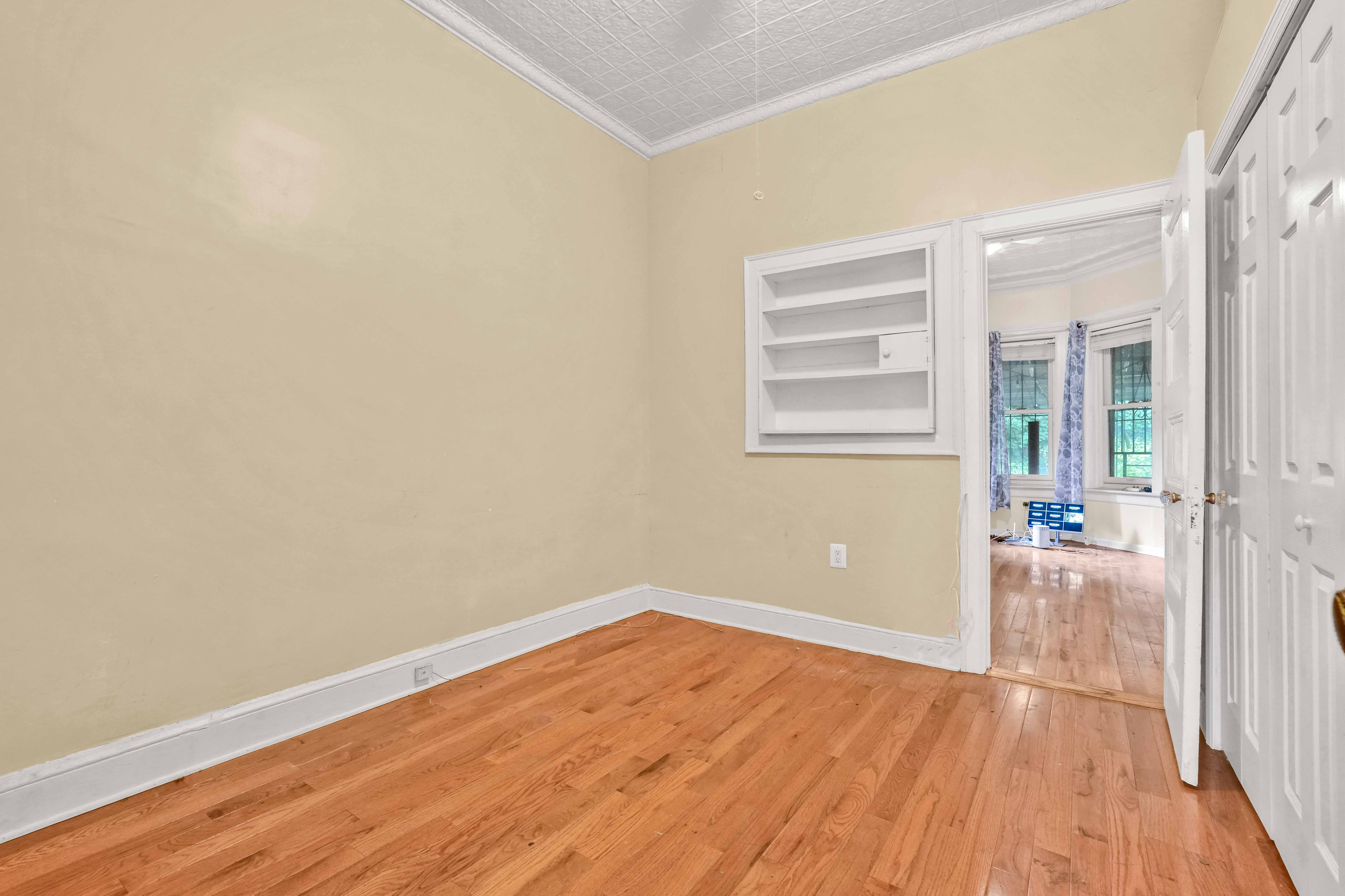 278 Lefferts Avenue Brooklyn, NY 11225 - Photo 40 of 56 an empty room with wooden floor and windows