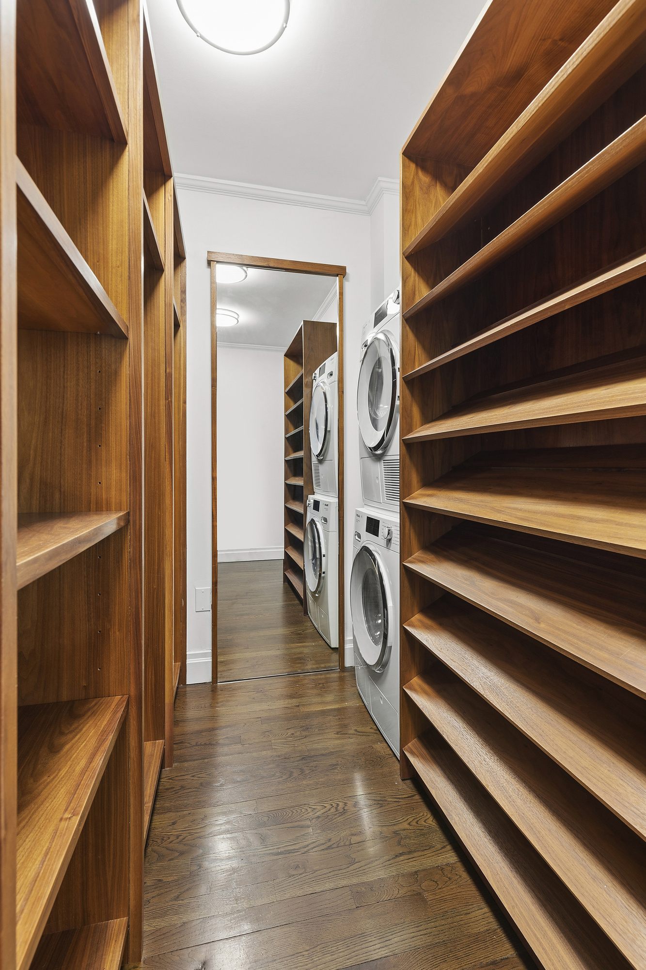 217 East 7th Street, Unit 5CD Manhattan, NY 10009 - Photo 6 of 11 a view of a hallway with wooden floor and staircase