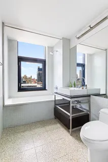 a spacious bathroom with a toilet a sink and a bathtub