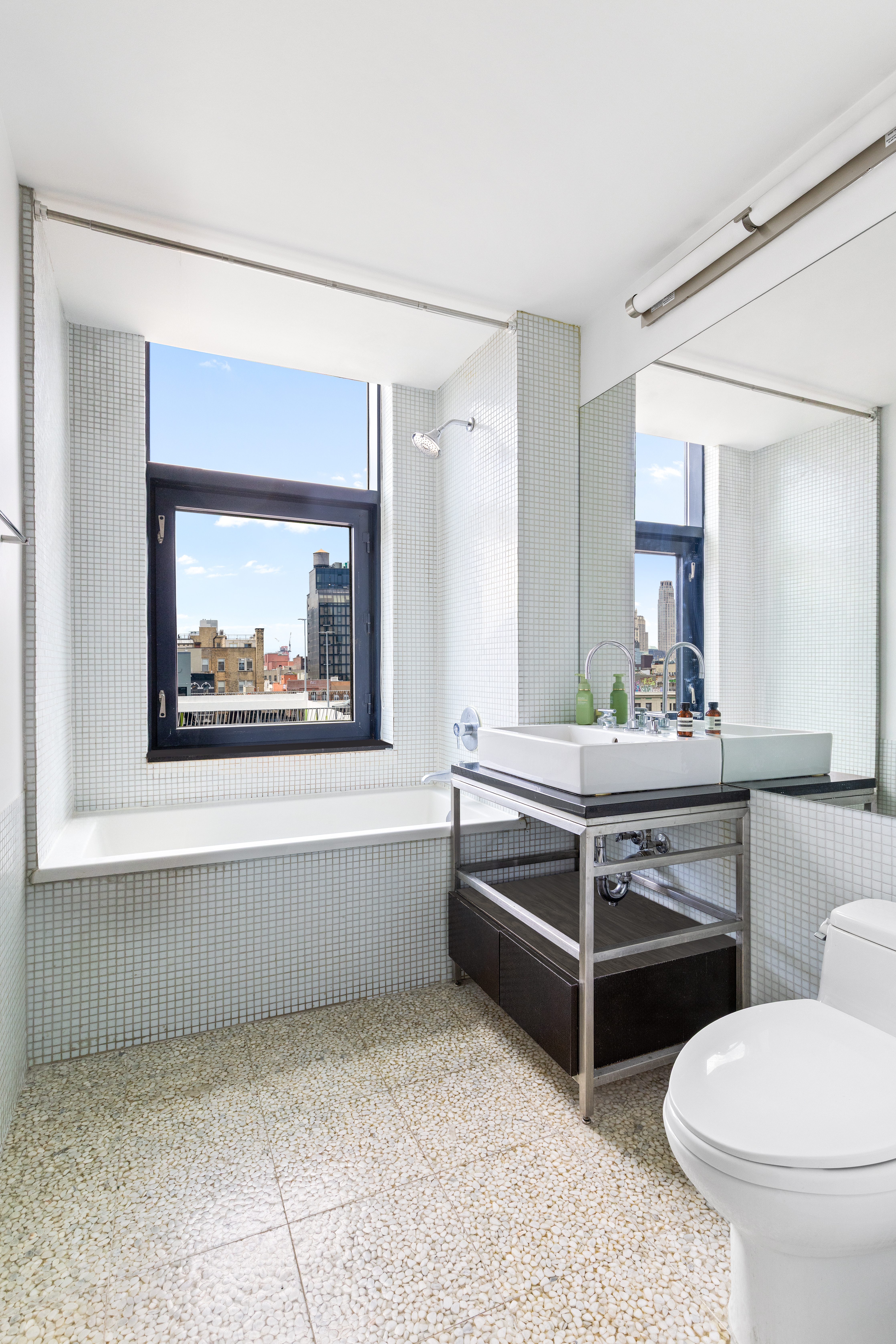 105 Norfolk Street, Unit 7A Manhattan, NY 10002 - Photo 7 of 14 a spacious bathroom with a toilet a sink and a bathtub