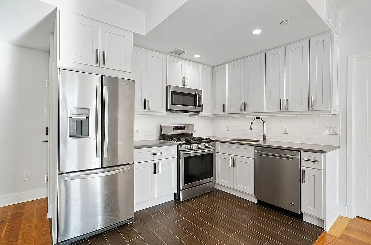 25 Lexington Avenue, Unit 202 Brooklyn, NY 11238 - Photo 2 of 7 a kitchen with stainless steel appliances a refrigerator sink and microwave