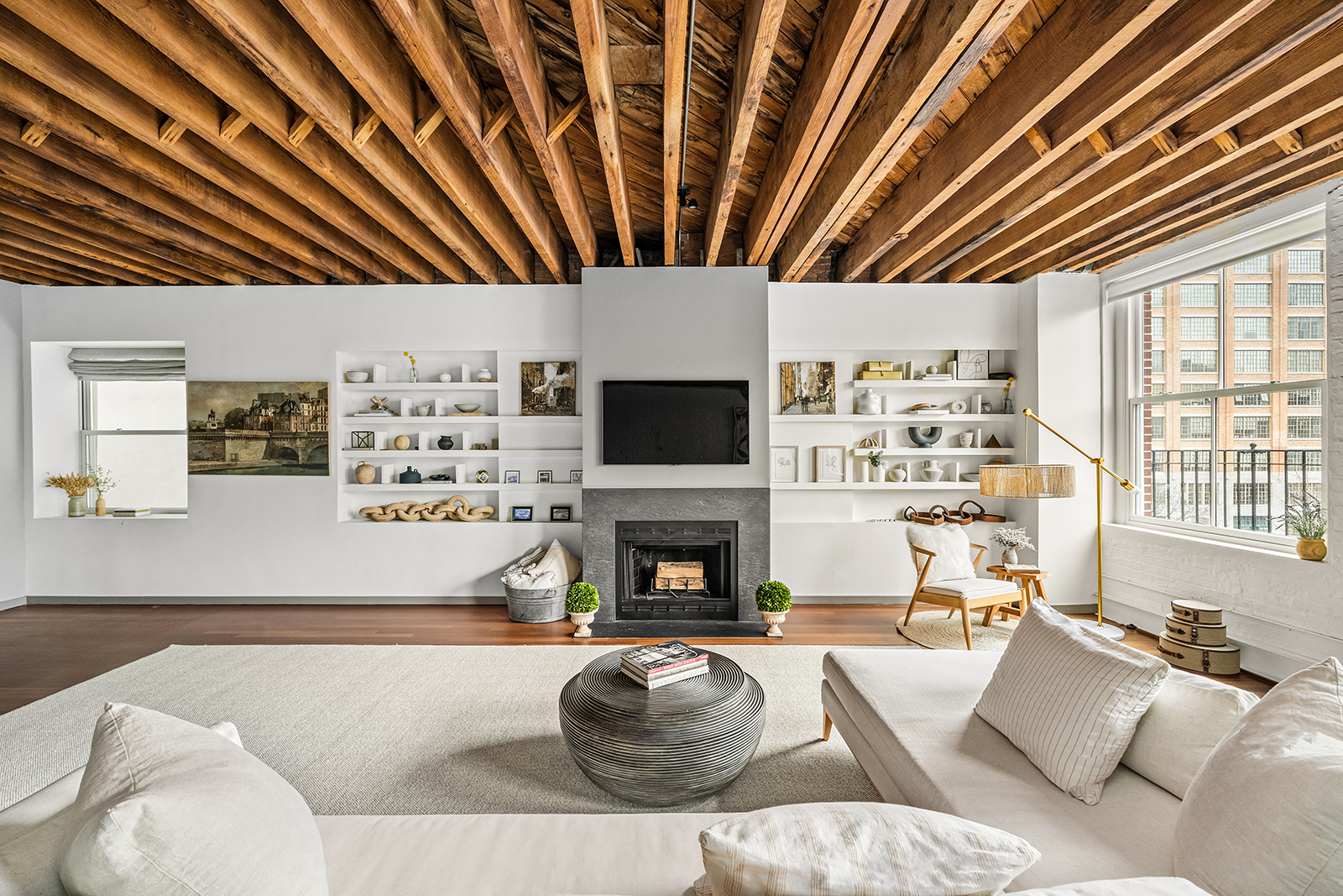 39 North Moore Street, Unit 4A Manhattan, NY 10013 - Photo 2 of 17 a living room with furniture a fireplace and a flat screen tv