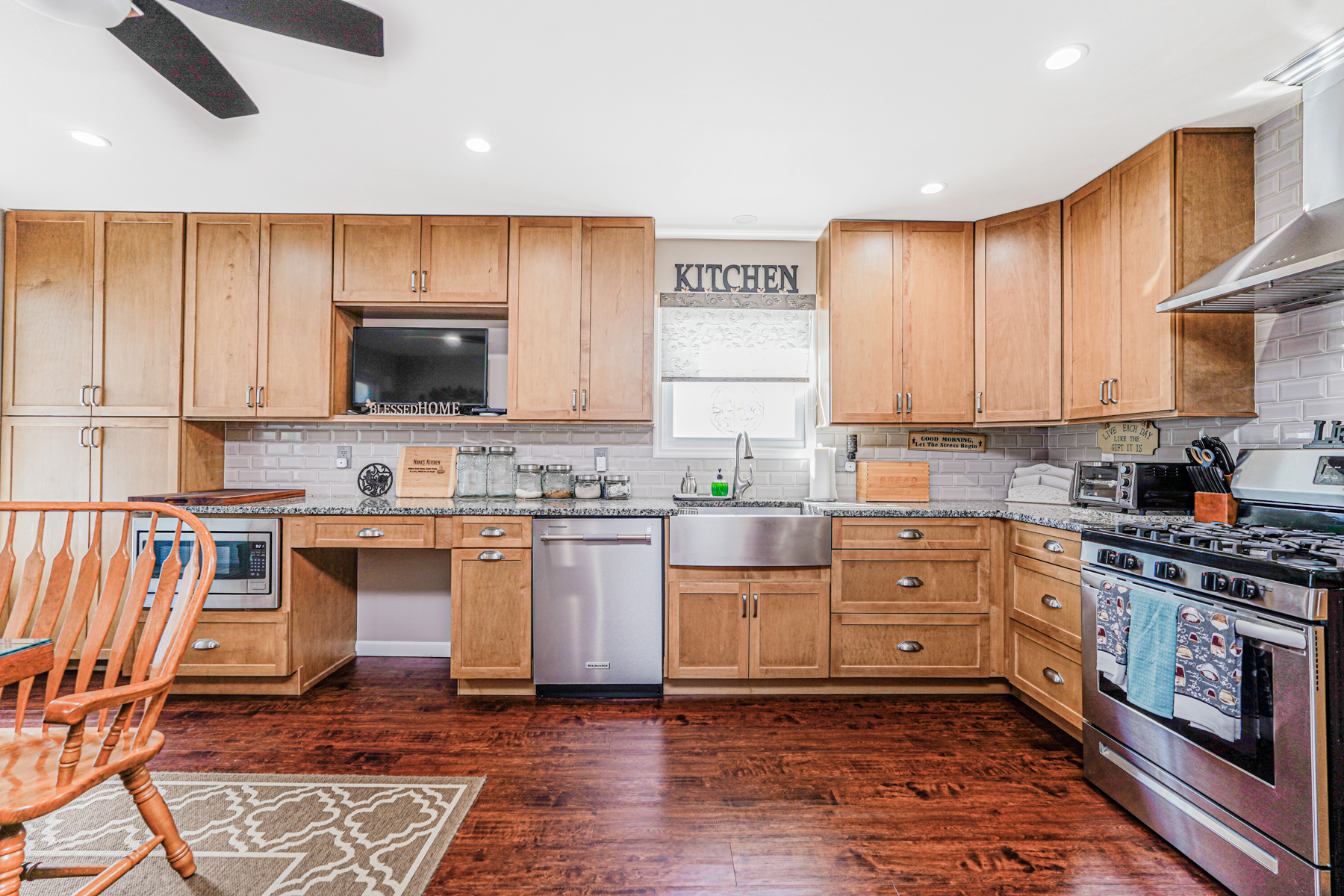 287 Greaves Avenue Staten Island, NY 10308 - Photo 9 of 35 a kitchen with stainless steel appliances a stove top oven a sink a counter space and cabinets