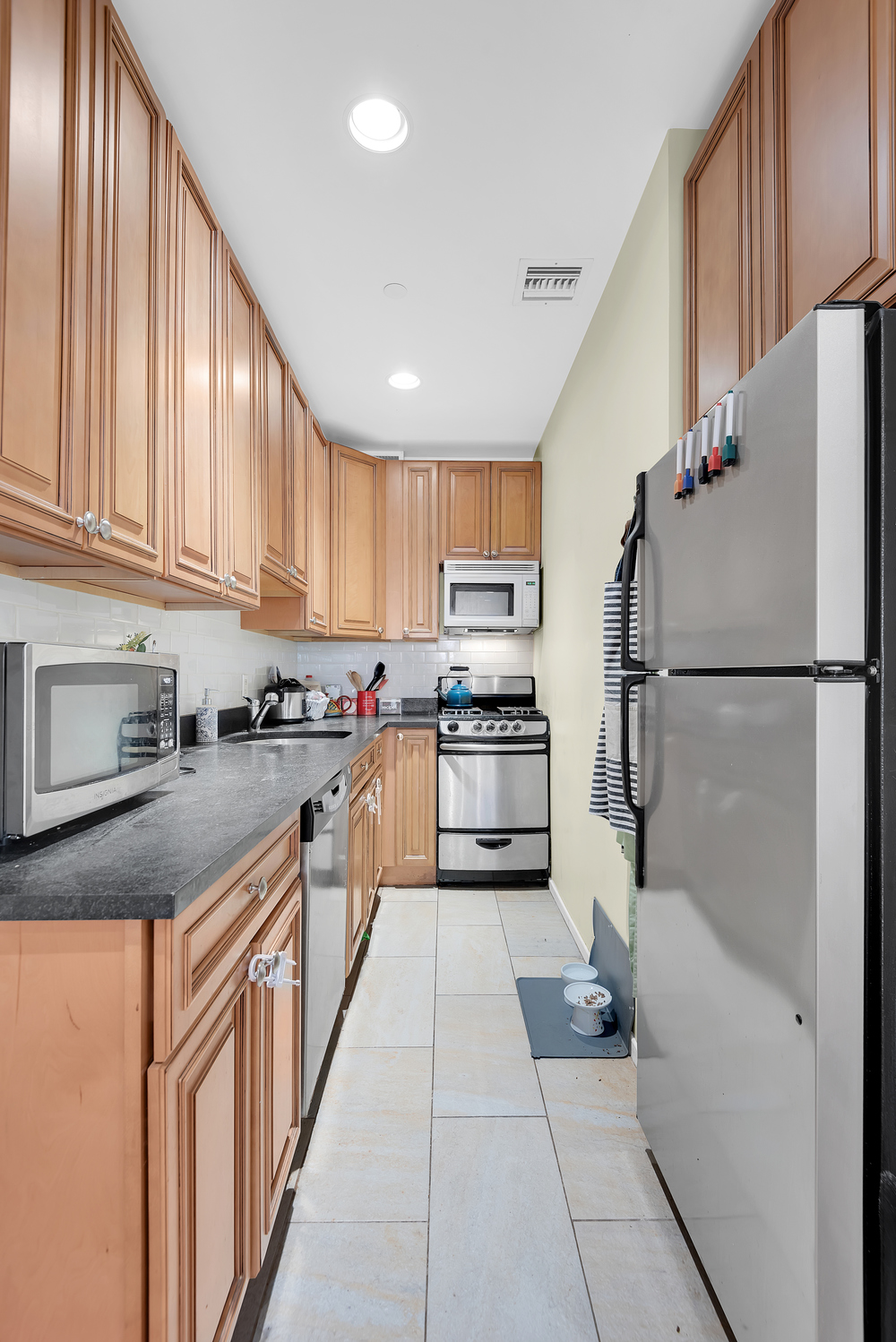 111 West 113th Street, Unit 3B Manhattan, NY 10026 - Photo 4 of 7 a kitchen with cabinets and a stainless steel appliances