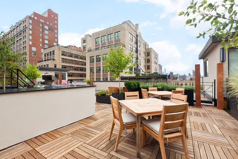 a view of a patio with a table and chairs