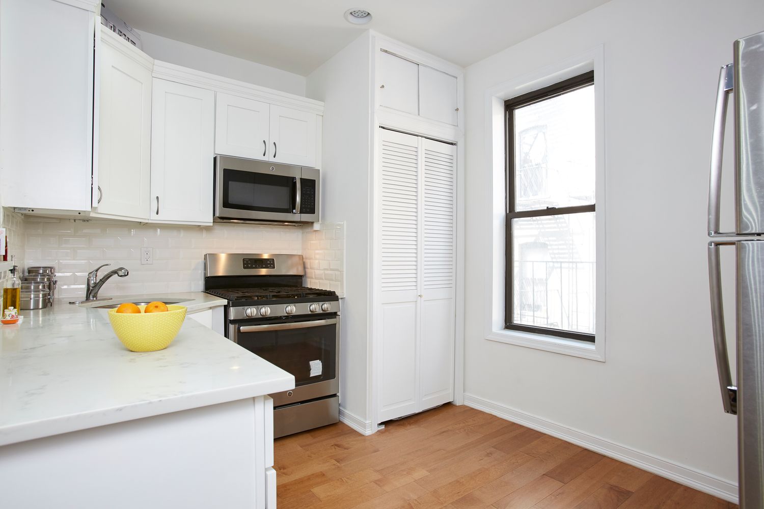 a kitchen with a sink a stove and wooden cabinets