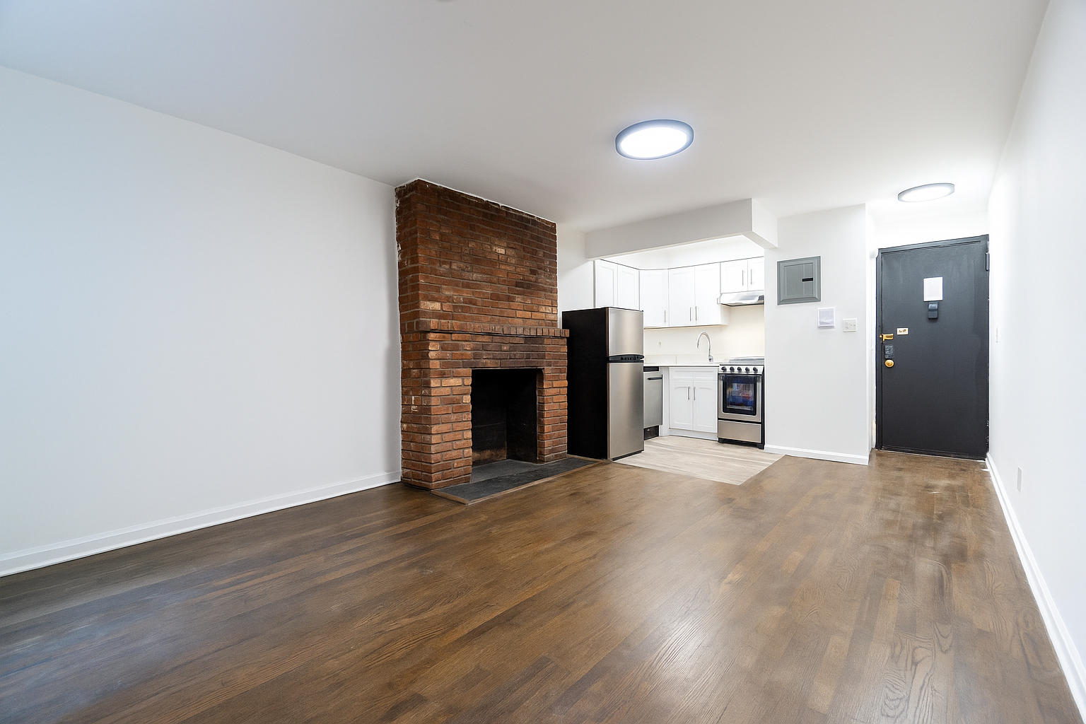 205 2nd Avenue, Unit 2C Manhattan, NY 10003 - Photo 6 of 15 a view of a kitchen with a stove cabinets and wooden floor