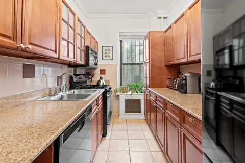 a kitchen with stainless steel appliances granite countertop a sink and cabinets