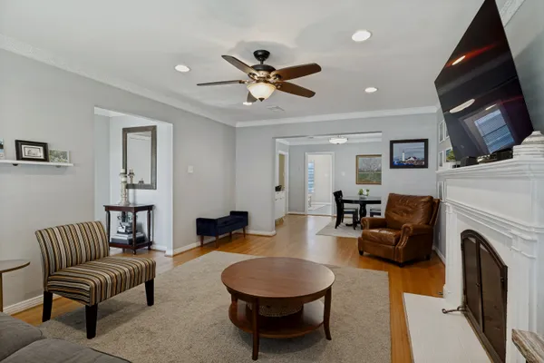 a living room with furniture a fireplace and a flat screen tv
