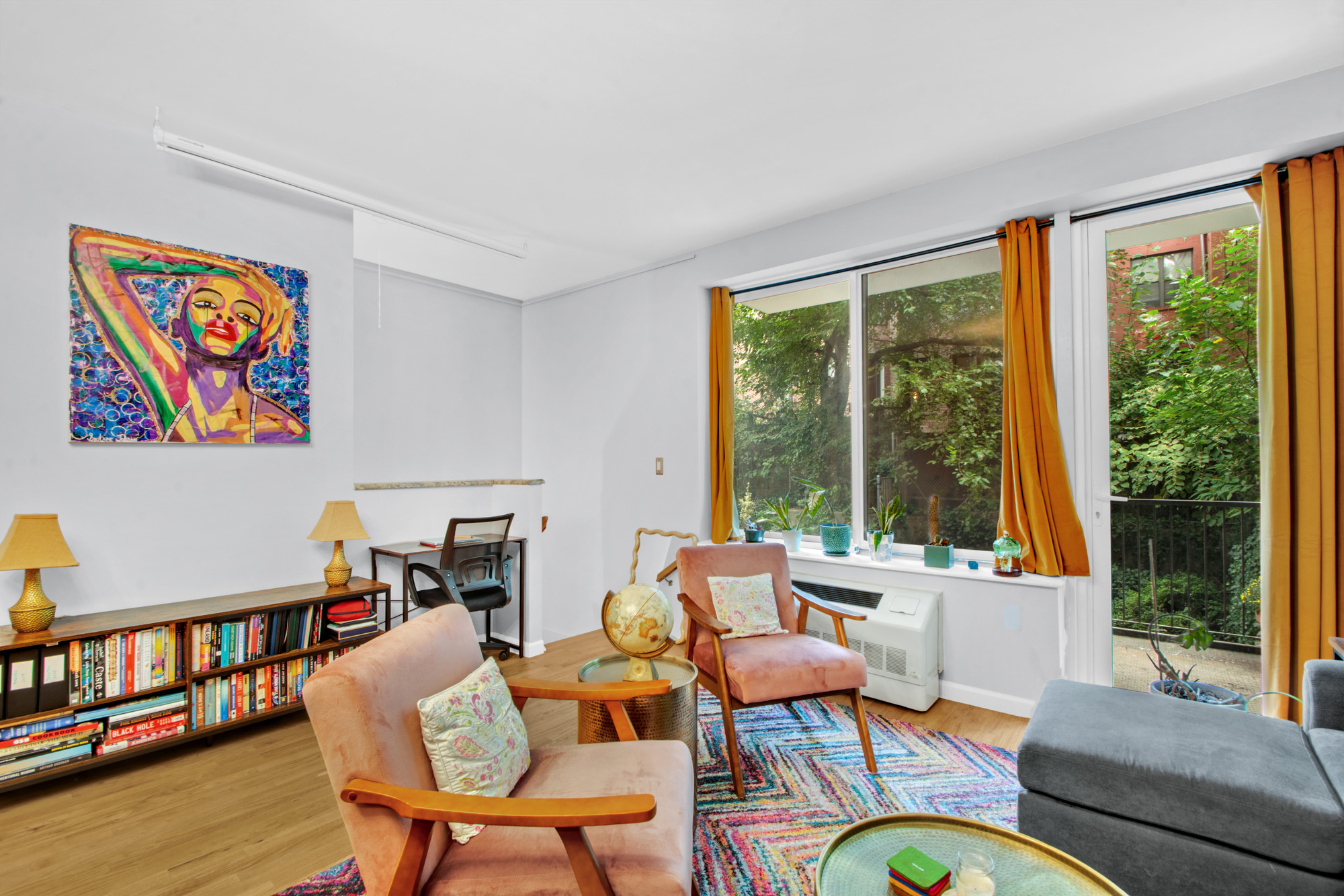 5 West 127th Street, Unit 1B Manhattan, NY 10027 - Photo 3 of 11 a living room with furniture and a large window