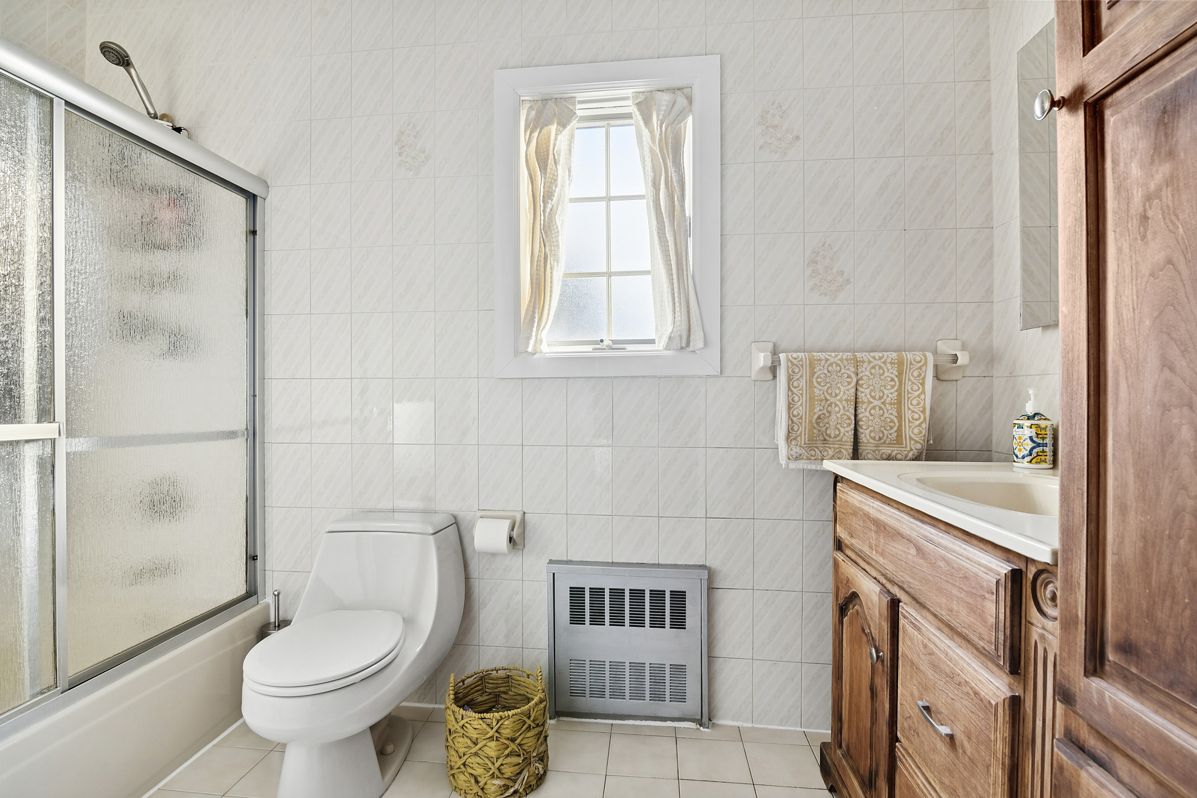 1384 East 29th Street Brooklyn, NY 11210 - Photo 9 of 21 a bathroom with a granite countertop toilet a sink and a shower