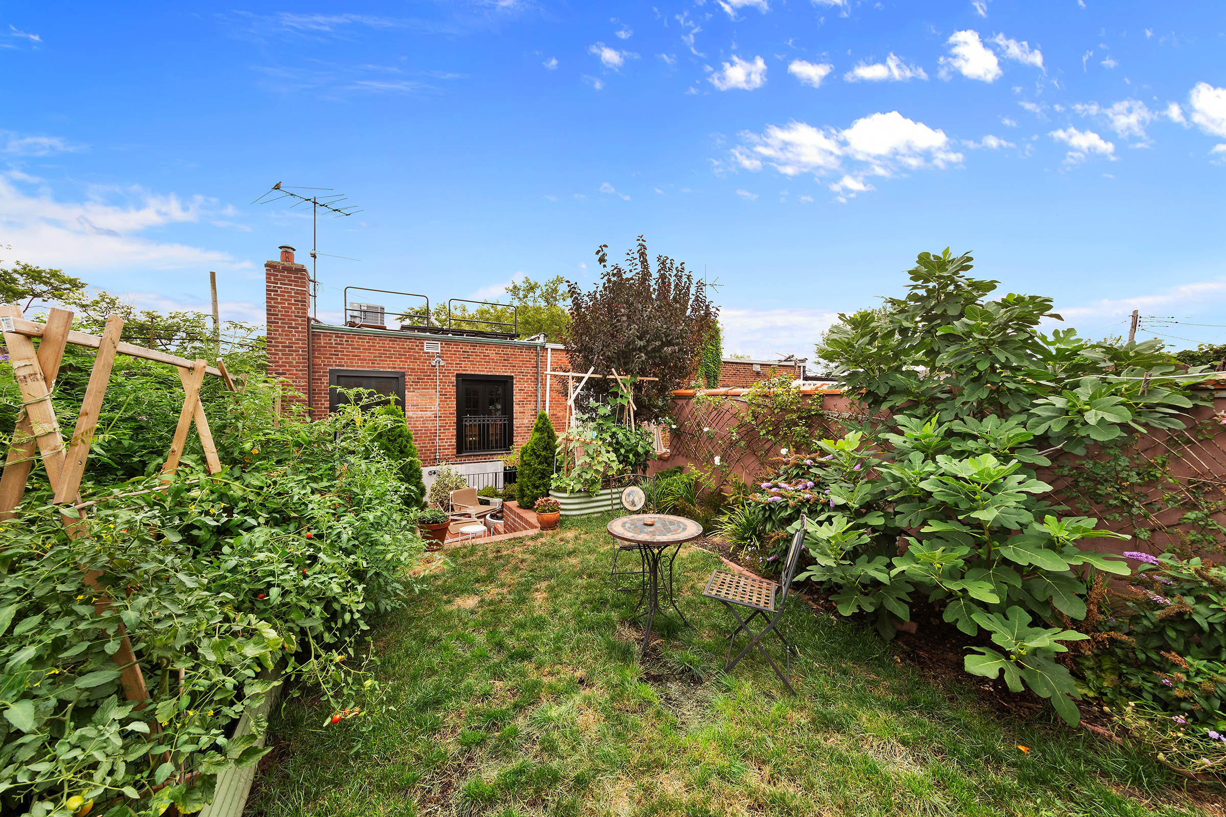 209 Onderdonk Avenue Queens, NY 11385 - Photo 15 of 16 a view of a house with a yard