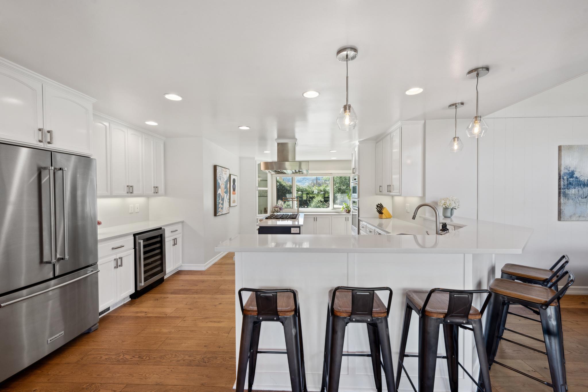 123 Frey Road Santa Rosa, CA 95409 - Photo 19 of 62 a kitchen with kitchen island granite countertop a table chairs microwave and cabinets